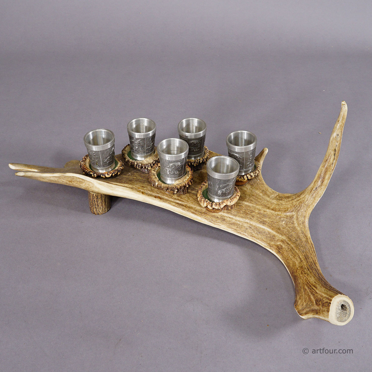 A Black Forest Rustic Drinking Set with Six Pewter Shot Glasses
