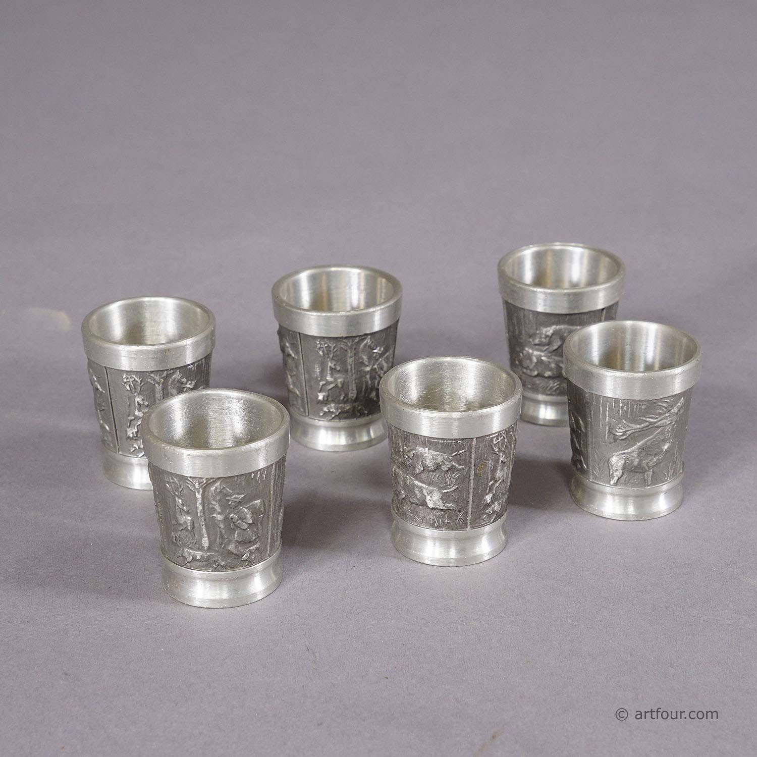 A Black Forest Rustic Drinking Set with Six Pewter Shot Glasses