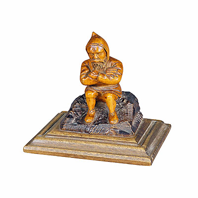 Wooden Carved Black Forest Dwarf Sitting on a Rock.